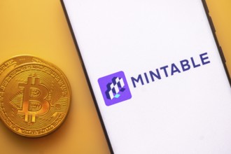 A Bitcoin and Mintable logo on a white screen with a purple square