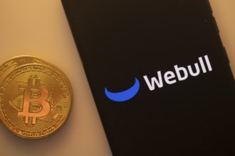 A Bitcoin coin next to a Webull logo on a black background