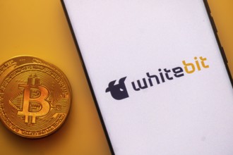 A Bitcoin coin next to a WhiteBIT logo on a white background