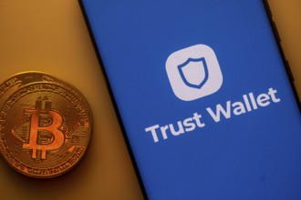 A Bitcoin coin next to a Trust Wallet logo on a blue background