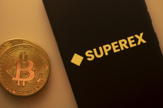 A Bitcoin coin next to a SupereX logo on a black background