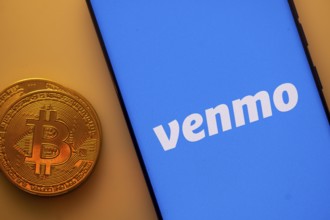 A Bitcoin and Venmo logo on a blue screen representing cryptocurrency