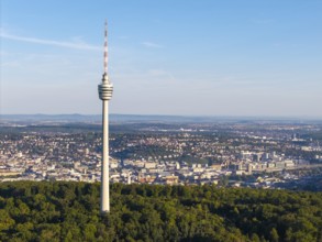 A television tower stands prominently above a vast urban landscape and green forests, Stuttgart,