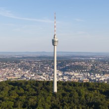 The television tower towers over a city surrounded by forests, under an expansive sky, Stuttgart,