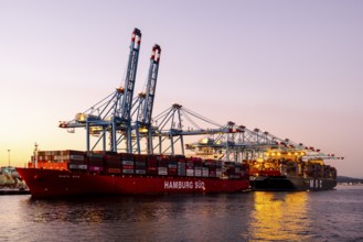 Gibraltar, UK - December 26, 2023: Container ship in the port during sunset