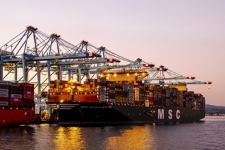 Gibraltar, UK - December 26, 2023: Container ship in the port during sunset