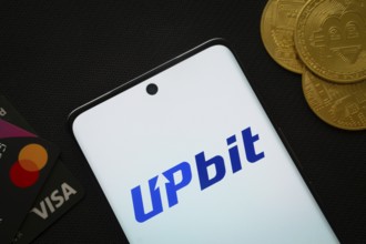 Dhaka, Bangladesh- 19 Sep 2025: Smartphone displaying Upbit logo surrounded by Bitcoin coins and