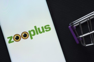 Dhaka, Bangladesh- 03 July 2025: A smartphone displaying the zooplus logo next to a miniature