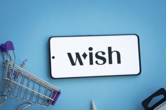 Dhaka, Bangladesh- 03 July 2025: Smartphone displaying Wish logo with shopping cart on a blue