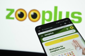 Dhaka, Bangladesh- 03 July 2025: Smartphone displaying zooplus web interface against Zooplus logo