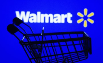Dhaka, Bangladesh- 03 July 2025: Silhouette of a shopping cart in front of the Walmart logo,