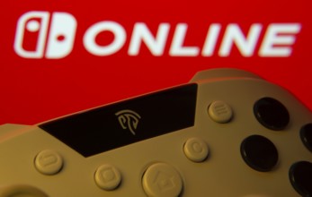Dhaka, Bangladesh- 15 July 2025: Game controller in front of nintendo online logo on a background