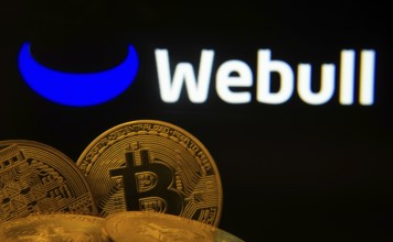 Dhaka, Bangladesh- 04 April 2025: Close-up of Bitcoin coins with the webull logo visible on a