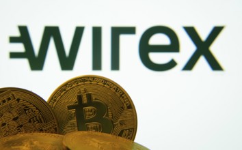 Dhaka, Bangladesh- 27 July 2025: Close-up of Bitcoin coins with the wirex logo visible on a screen