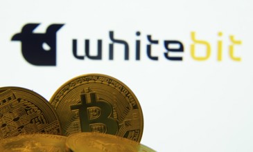Dhaka, Bangladesh- 03 Sep 2025: Close-up of Bitcoin coins with the whitebit logo visible on a