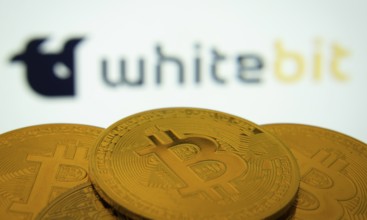 Dhaka, Bangladesh- 03 Sep 2025: Close-up of Bitcoin coins with the whitebit logo visible on a