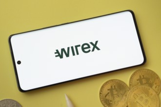 Dhaka, Bangladesh- 26 Aug 2025: wirex logo on smartphone screen near Bitcoin coin and QR code on