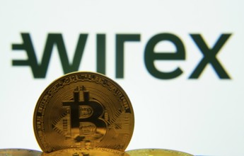 Dhaka, Bangladesh- 04 April 2025: Close-up of Bitcoin coins with the wirex logo visible on a screen