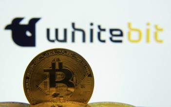 Dhaka, Bangladesh- 03 Sep 2025: Close-up of Bitcoin coins with the whitebit logo visible on a