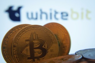 Dhaka, Bangladesh- 03 Sep 2025: Close-up of Bitcoin coins with the whitebit logo visible on a