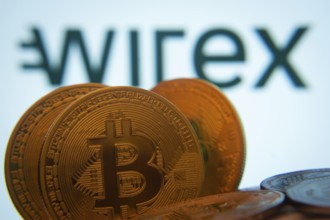 Dhaka, Bangladesh- 02 June 2025: Close-up of Bitcoin coins with the wirex logo visible on a screen