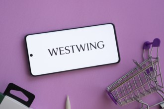 Dhaka, Bangladesh- 03 July 2025: Smartphone displaying Westwing logo alongside a shopping cart on a