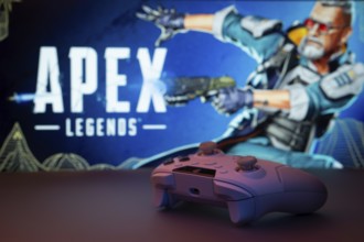 Dhaka, Bangladesh- 19 Sep 2025: A close-up of a white gamepad with the Apex Legends seen on screen