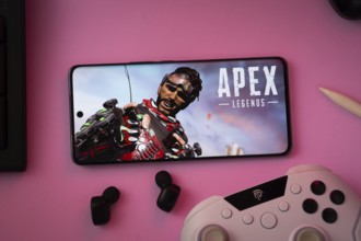 Dhaka, Bangladesh- 19 Sep 2025: A close-up of a white gamepad with the Apex Legends mobile seen on