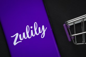 Dhaka, Bangladesh- 03 July 2025: A smartphone displaying the Zulily logo next to a miniature