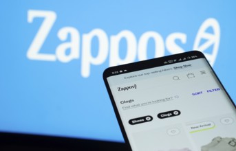 Dhaka, Bangladesh- 03 July 2025: Smartphone displaying Zappos web interface against Zappos logo