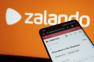 Dhaka, Bangladesh- 03 July 2025: Smartphone displaying Zalando web interface against Zalando logo