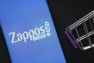 Dhaka, Bangladesh- 03 July 2025: A smartphone displaying the Zappos logo next to a miniature
