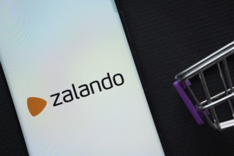 Dhaka, Bangladesh- 03 July 2025: A smartphone displaying the Zalando logo next to a miniature