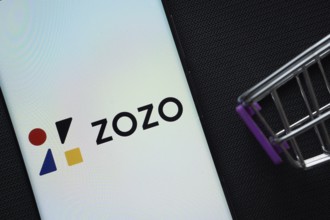 Dhaka, Bangladesh- 03 July 2025: A smartphone displaying the ZOZO logo next to a miniature shopping