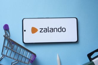 Dhaka, Bangladesh- 03 July 2025: Smartphone displaying Zalando logo with shopping cart on a blue