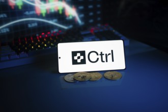 Phone showing Ctrl logo with coins and an analytical trading screen backdrop