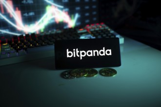 Bitpanda display with coins set against a stock chart with a turquoise neon glow