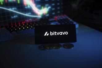 Bitvavo display with coins in front of a lit stock chart in blue neon ambiance