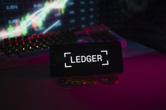 LEDGER logo with coins and trading charts, highlighted by neon-illuminated background