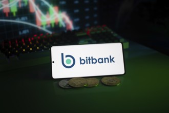 Bitbank logo displayed with coins and market charts, surrounded by neon lighting