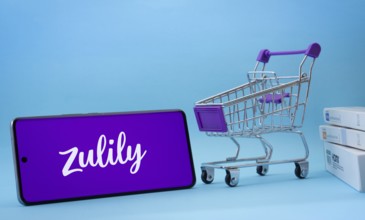 Dhaka, Bangladesh- 03 July 2025: Smartphone with Zulily logo next to a small shopping cart and