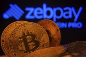 Dhaka, Bangladesh- 02 June 2025: Close-up of Bitcoin coins with the zebpay logo visible on a screen