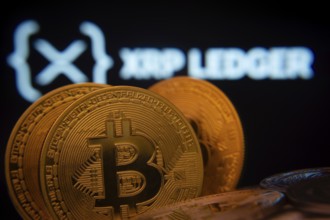 Dhaka, Bangladesh- 03 Sep 2025: Close-up of Bitcoin coins with the XRP Ledger logo visible on a