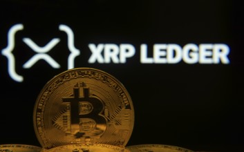 Dhaka, Bangladesh- 03 Sep 2025: Close-up of Bitcoin coins with the XRP Ledger logo visible on a