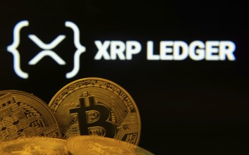 Dhaka, Bangladesh- 27 July 2025: Close-up of Bitcoin coins with the XRP Ledger logo visible on a