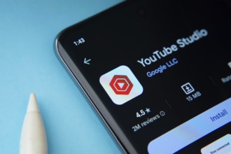 Dhaka, Bangladesh- 29 May 2025: On a blue surface, a smartphone displays the youtube studio app