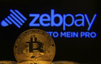 Dhaka, Bangladesh- 04 April 2025: Close-up of Bitcoin coins with the ZebPay logo visible on a