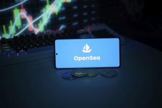 OpenSea on a smartphone with coins and market data on a screen