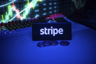 Stripe shown on a smartphone surrounded by coins and trading visuals