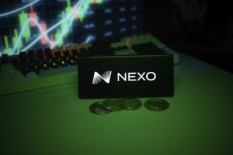 NEXO on a smartphone with currency tokens and fluctuating charts behind